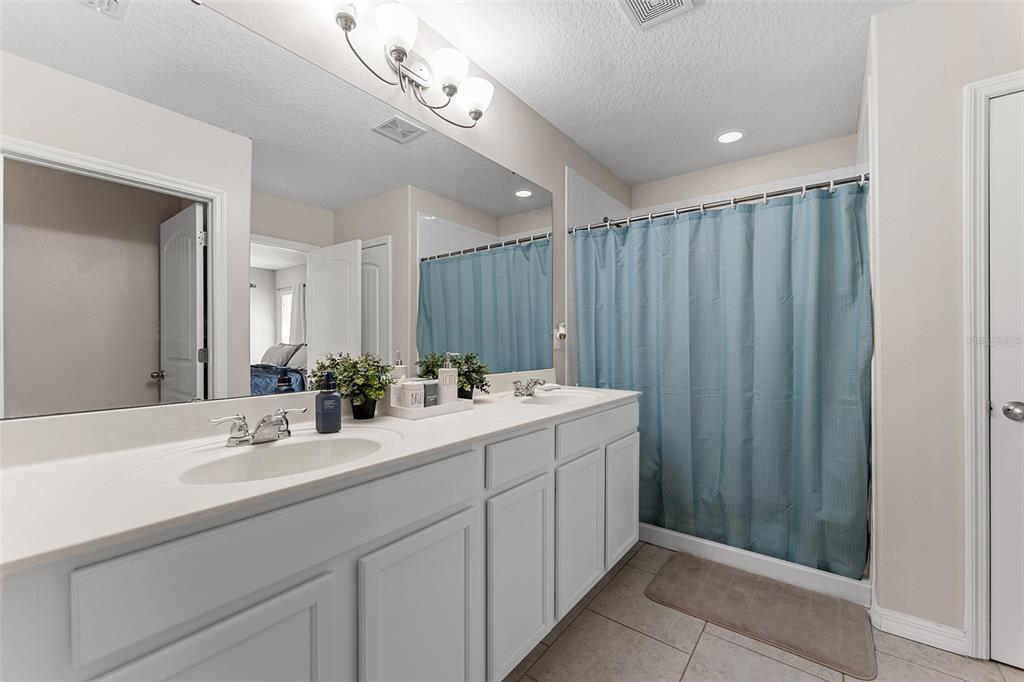 3523 Clay Brick Road St. Cloud, FL 34773 - Photo 25 of 62 a bathroom with a double vanity sink and a mirror
