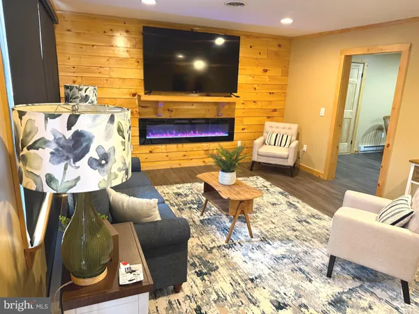 a living room with fireplace furniture and a flat screen tv