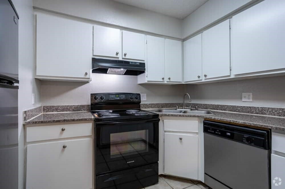 6505 Westheimer Road, Unit 147 Houston, TX 77057 - Photo 1 of 16 a kitchen with granite countertop white cabinets and appliances