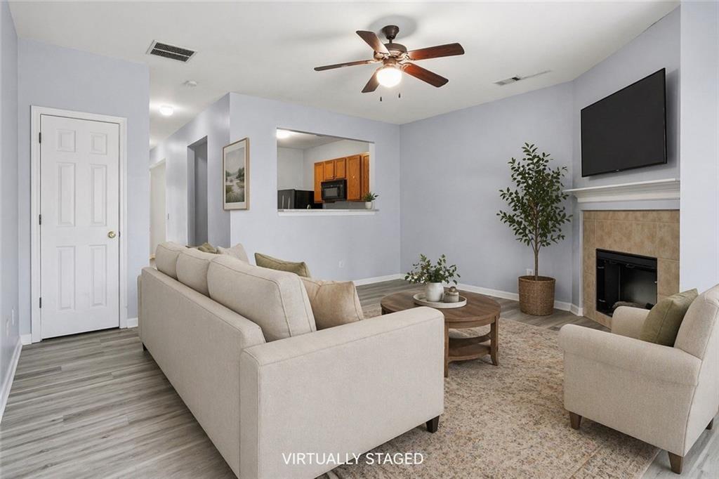 585 McWilliams Road Southeast, Unit 2402 Atlanta, GA 30315 - Photo 13 of 25 a living room with furniture a fireplace and a flat screen tv