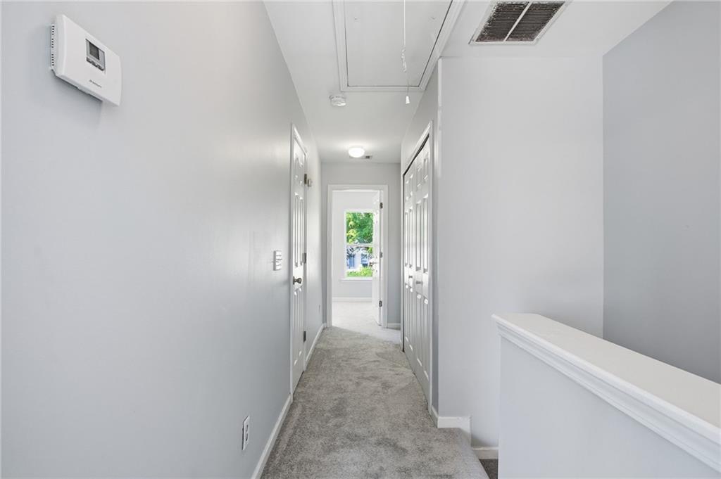 585 McWilliams Road Southeast, Unit 2402 Atlanta, GA 30315 - Photo 15 of 25 a view of a hallway with white walls