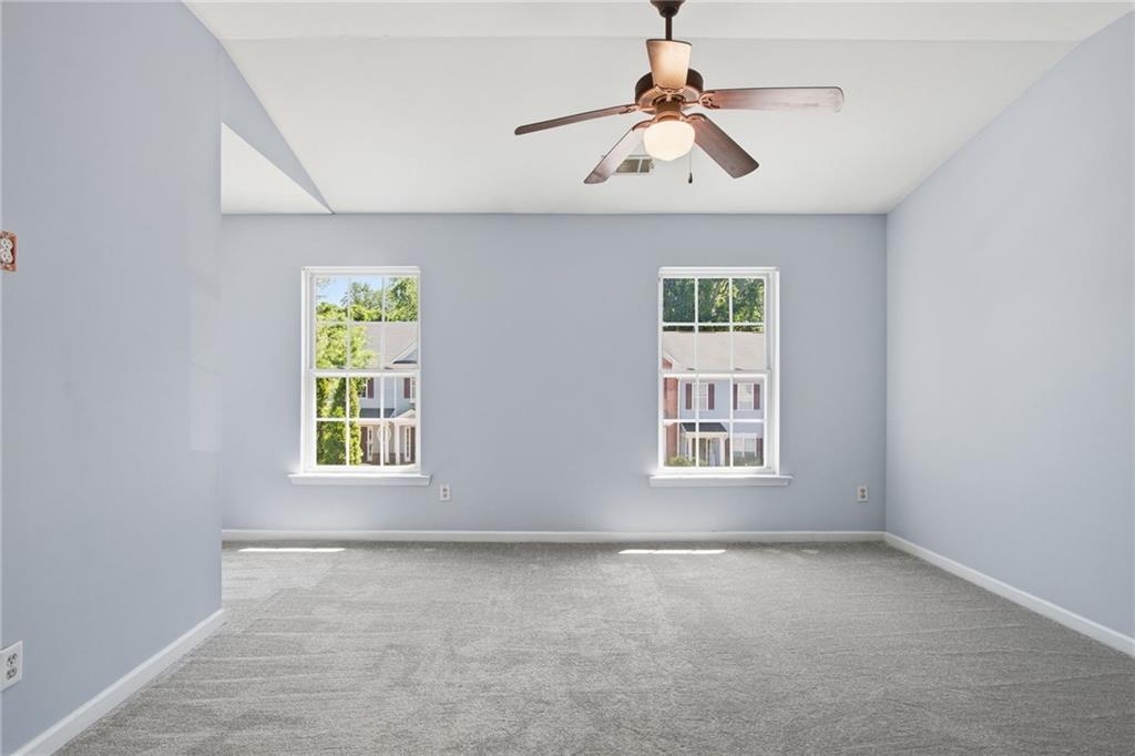 585 McWilliams Road Southeast, Unit 2402 Atlanta, GA 30315 - Photo 18 of 25 an empty room with windows and fan