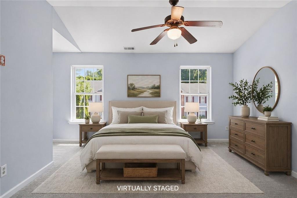 585 McWilliams Road Southeast, Unit 2402 Atlanta, GA 30315 - Photo 20 of 25 a bedroom with a large bed and a chandelier