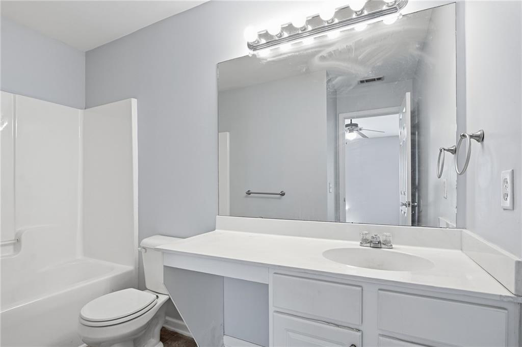 585 McWilliams Road Southeast, Unit 2402 Atlanta, GA 30315 - Photo 21 of 25 a bathroom with a sink a toilet and shower