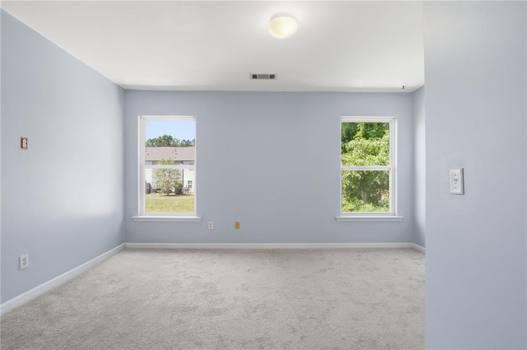 585 McWilliams Road Southeast, Unit 2402 Atlanta, GA 30315 - Photo 23 of 25 an empty room with windows