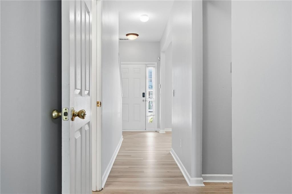 585 McWilliams Road Southeast, Unit 2402 Atlanta, GA 30315 - Photo 3 of 25 a view of a hallway with wooden floor