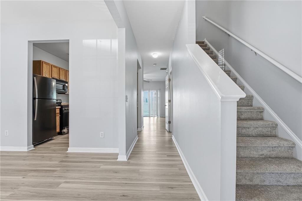 585 McWilliams Road Southeast, Unit 2402 Atlanta, GA 30315 - Photo 4 of 25 a view of a hallway with wooden floor and staircase