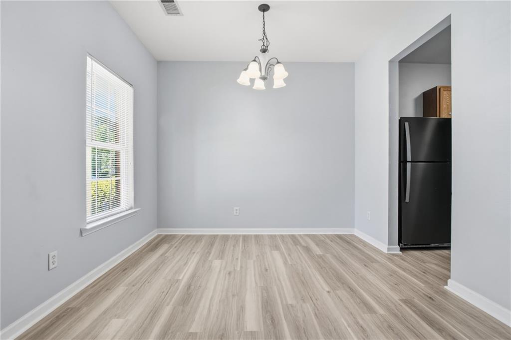 585 McWilliams Road Southeast, Unit 2402 Atlanta, GA 30315 - Photo 5 of 25 a view of empty room with wooden floor and window