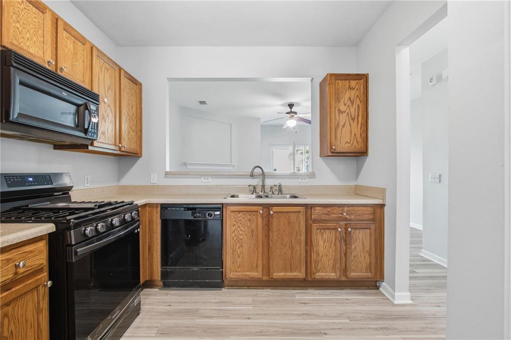 585 McWilliams Road Southeast, Unit 2402 Atlanta, GA 30315 - Photo 7 of 25 a kitchen with stainless steel appliances granite countertop a stove a sink and a microwave