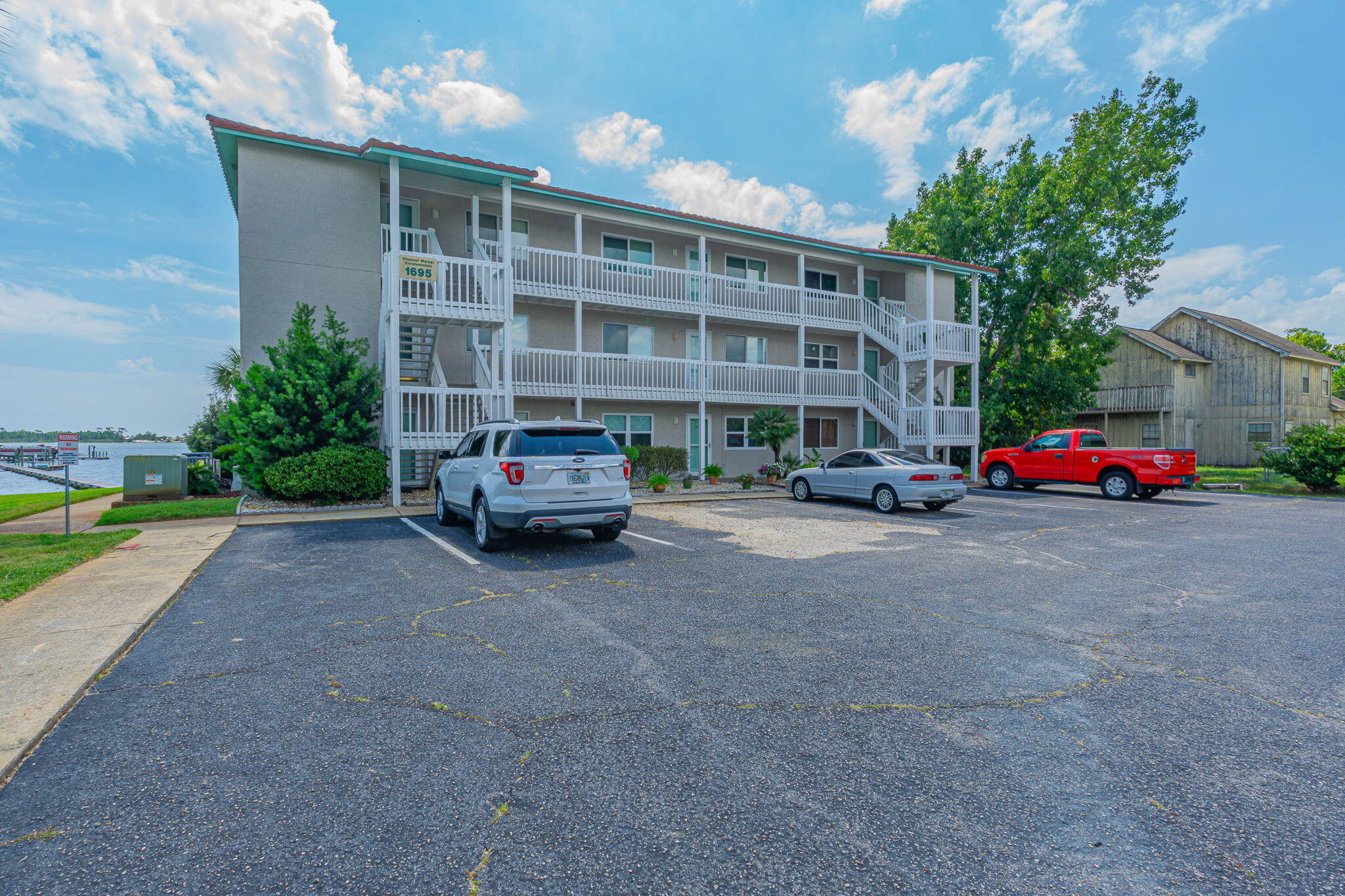 1695 Highway 98, Unit 102 Mary Esther, FL 32569 - Photo 1 of 27 a building with cars parked in front of it