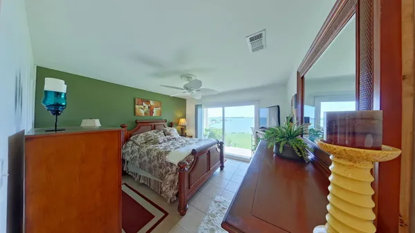 a bed room with a bed window and potted plant