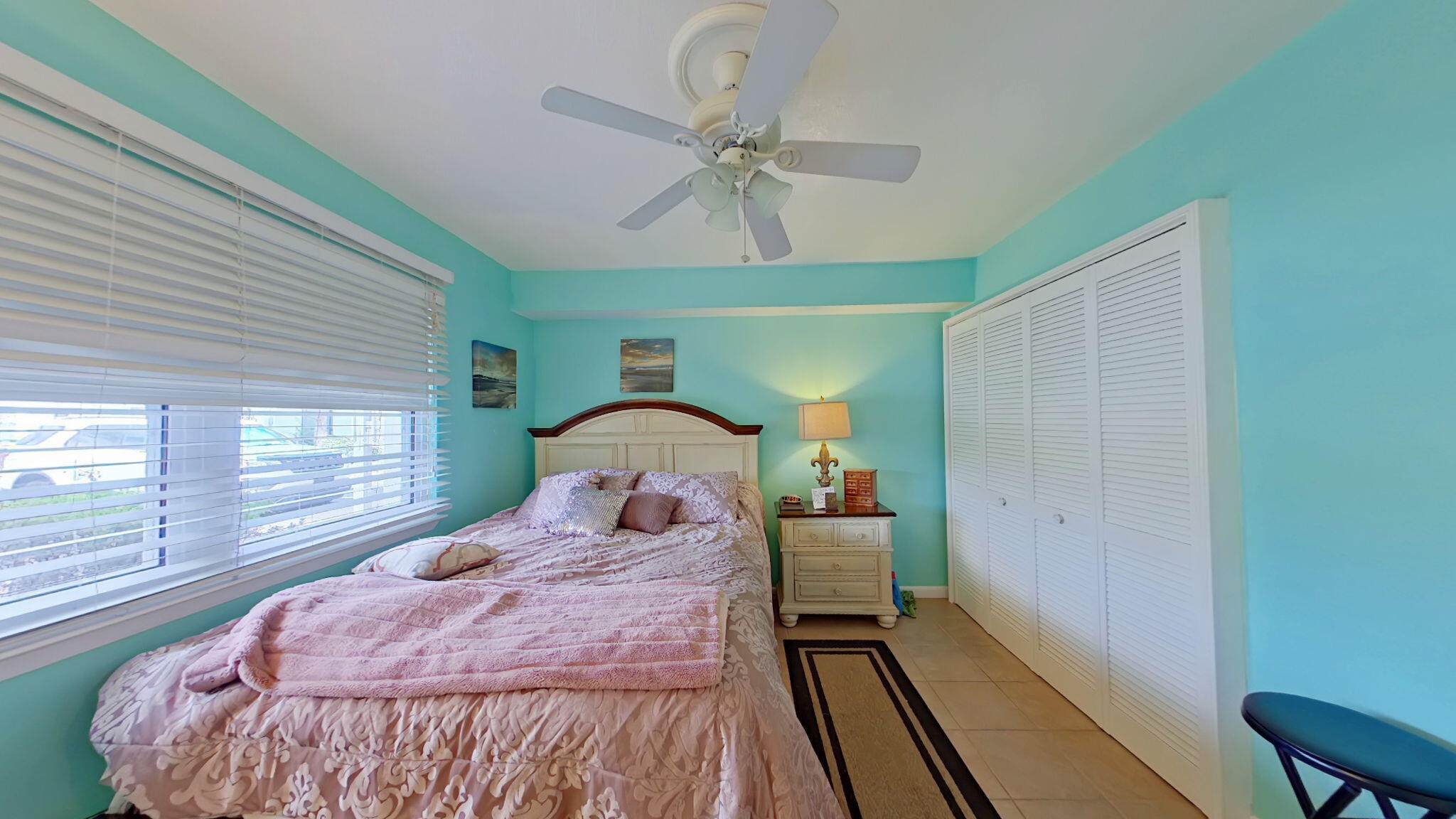 1695 Highway 98, Unit 102 Mary Esther, FL 32569 - Photo 19 of 27 a bedroom with a bed and a large window with wooden floor