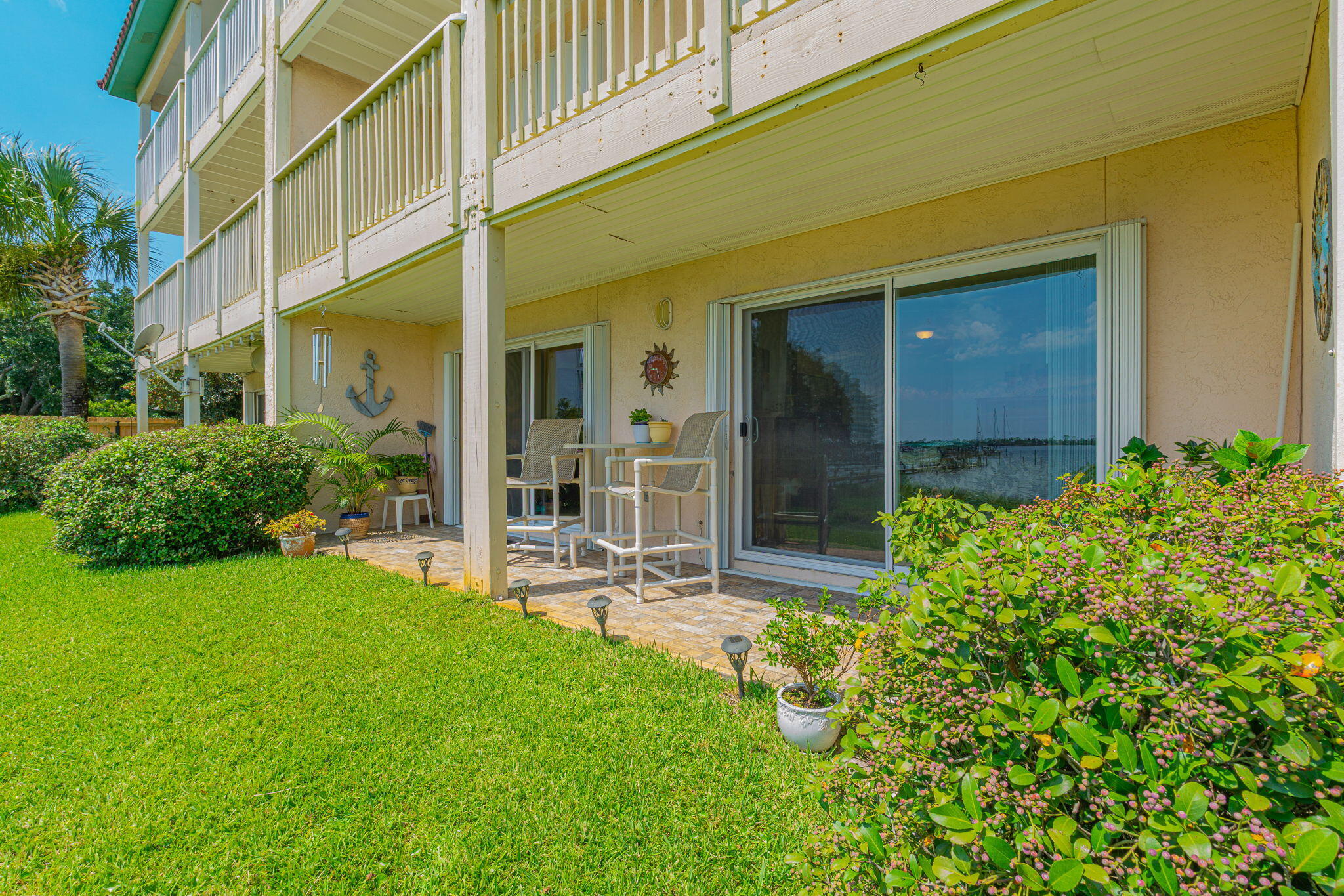 1695 Highway 98, Unit 102 Mary Esther, FL 32569 - Photo 24 of 27 a view of a chair and table in back yard of the house