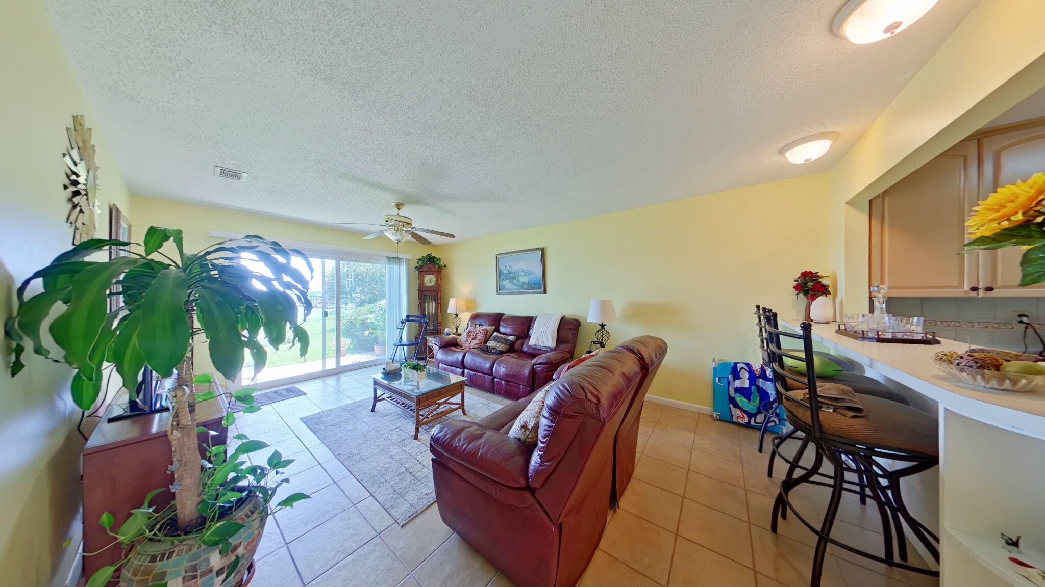 1695 Highway 98, Unit 102 Mary Esther, FL 32569 - Photo 5 of 27 a living room with furniture a chandelier and a potted plant