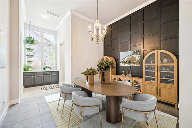 a dining room with furniture a chandelier and wooden floor