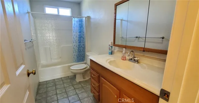 a bedroom with a bed and a mirror on dresser