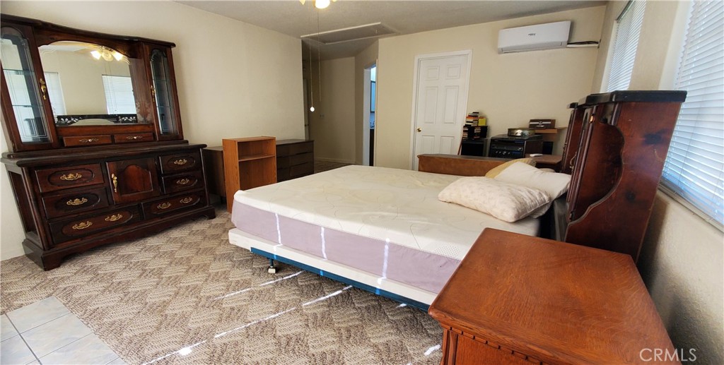 7486 Rodger Road Corning, CA 96021 - Photo 17 of 45 a bedroom with a bed and a mirror on dresser