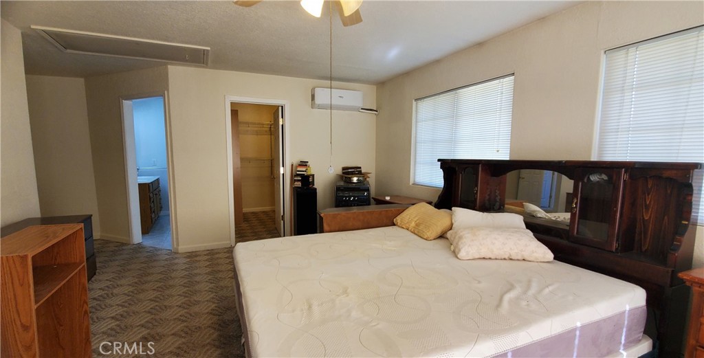 7486 Rodger Road Corning, CA 96021 - Photo 18 of 45 a bedroom with a bed and wooden floor