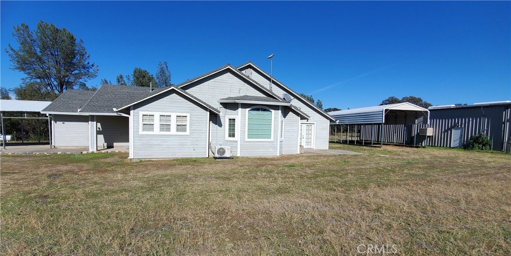 7486 Rodger Road Corning, CA 96021 - Photo 2 of 45 a front view of a house with a yard and garage
