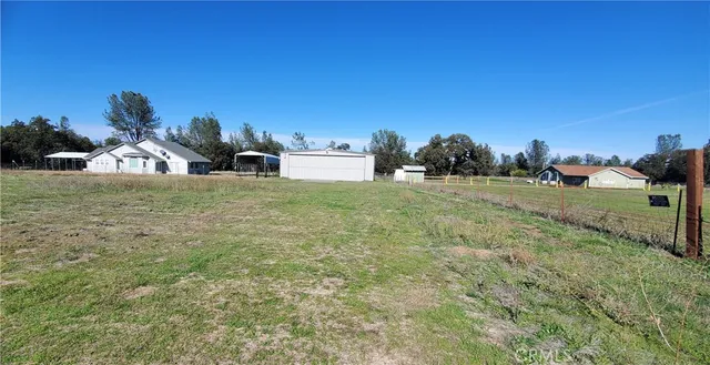 a view of house with outdoor space and sitting area