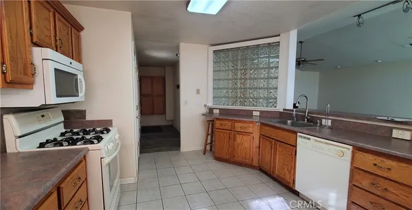 a kitchen with stainless steel appliances kitchen island granite countertop a sink stove and cabinets