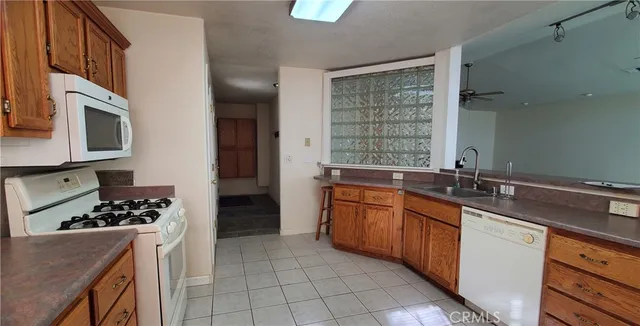 a kitchen with stainless steel appliances kitchen island granite countertop a sink stove and cabinets