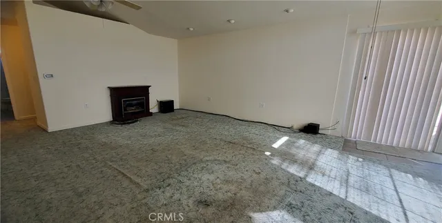 a view of an empty room with a fireplace