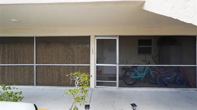 a front view of a house with a potted plant