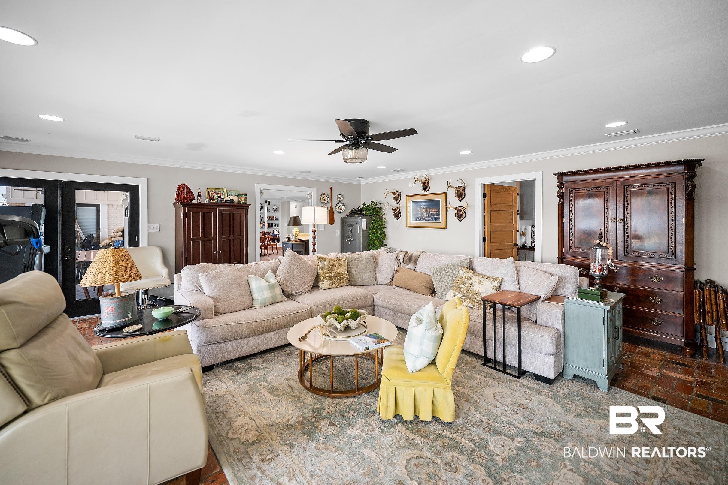 8490 Bay View Drive Foley, AL 36535 - Photo 26 of 67 Living room featuring crown molding, a ceiling fan, recessed lighting, and brick floors