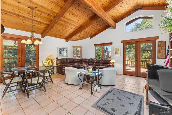 a view of a dining room with furniture wooden floor and a chandelier
