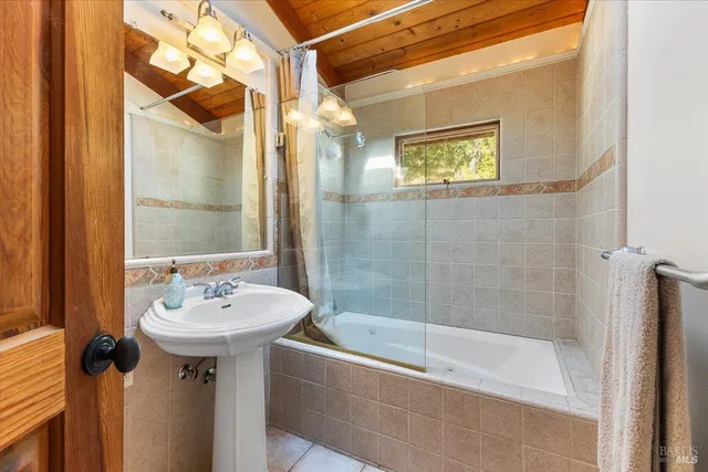 a bathroom with a sink a mirror and a bathtub