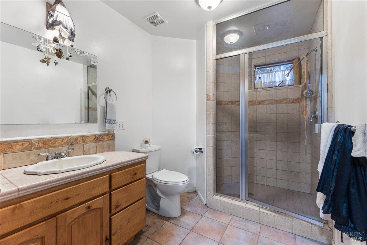 5262 Wikiup Court Santa Rosa, CA 95403 - Photo 16 of 43 a bathroom with a sink a toilet and shower