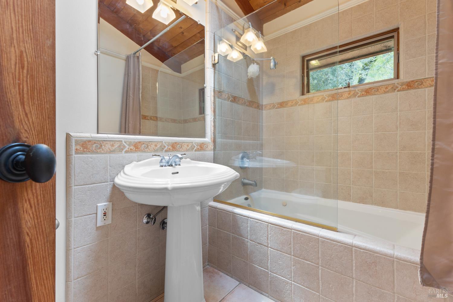 5262 Wikiup Court Santa Rosa, CA 95403 - Photo 20 of 56 a bathroom with a sink a mirror and a bathtub