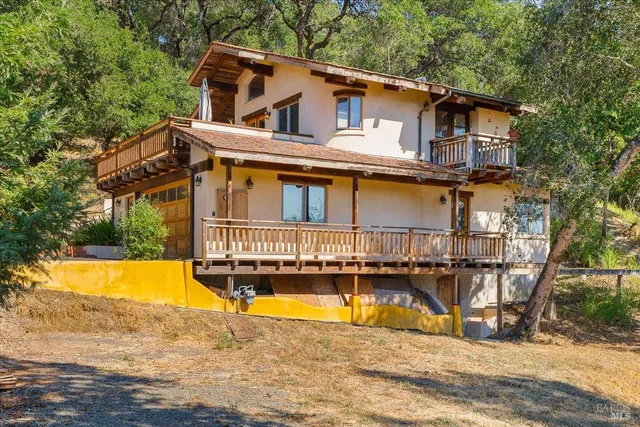a view of a house with pool and chairs