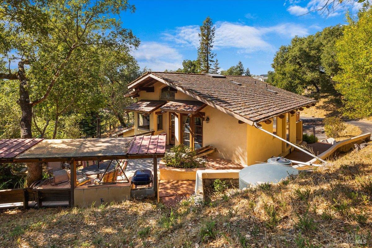 5262 Wikiup Court Santa Rosa, CA 95403 - Photo 30 of 56 a roof deck with table and chairs under an umbrella