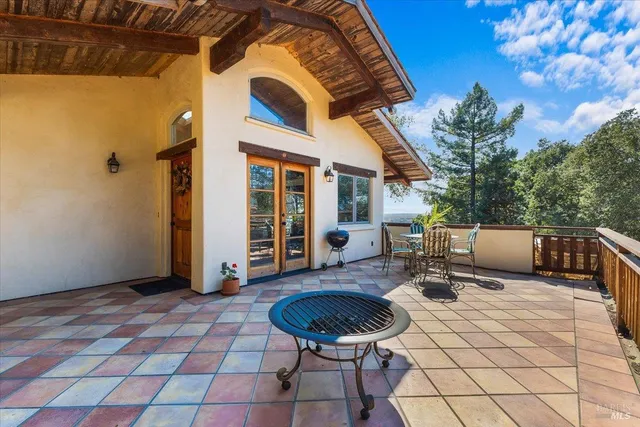 a view of a patio with a table and chairs