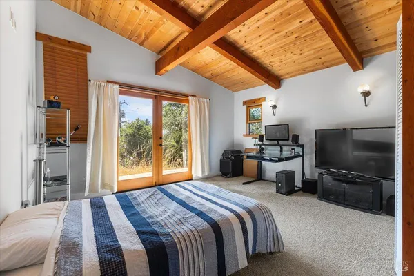 a bedroom with a bed and a television