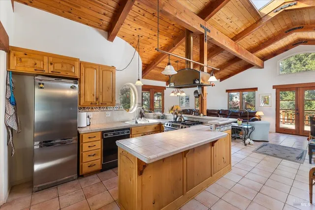 a kitchen with sink cabinets and stove top oven