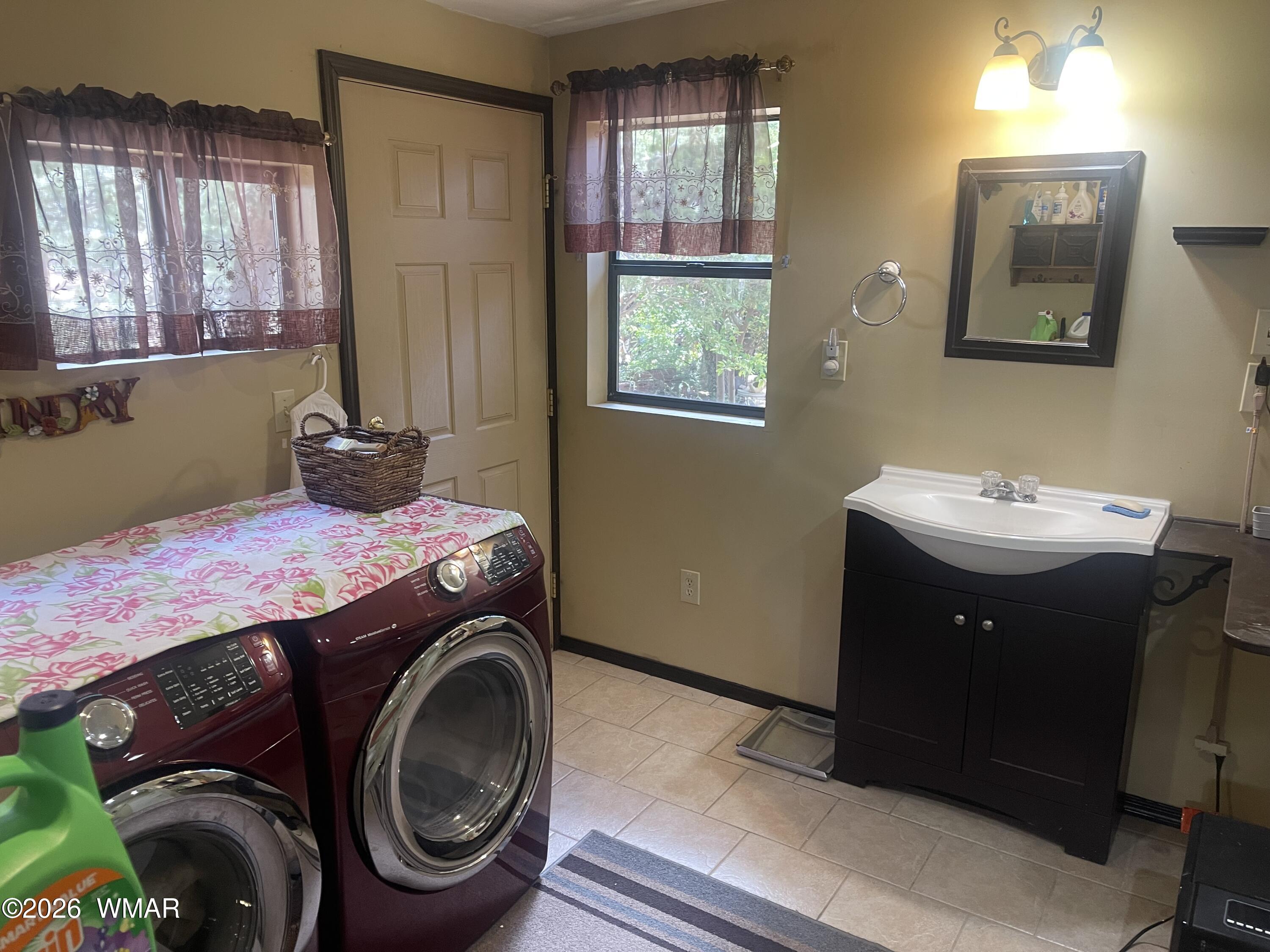 2871 Moose Trail Overgaard, AZ 85933 - Photo 20 of 25 a utility room with a sink a washer and dryer