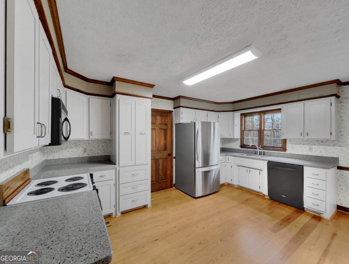 158 Lakeover Drive Athens, GA 30607 - Photo 12 of 48 a kitchen with stainless steel appliances granite countertop a refrigerator sink and stove