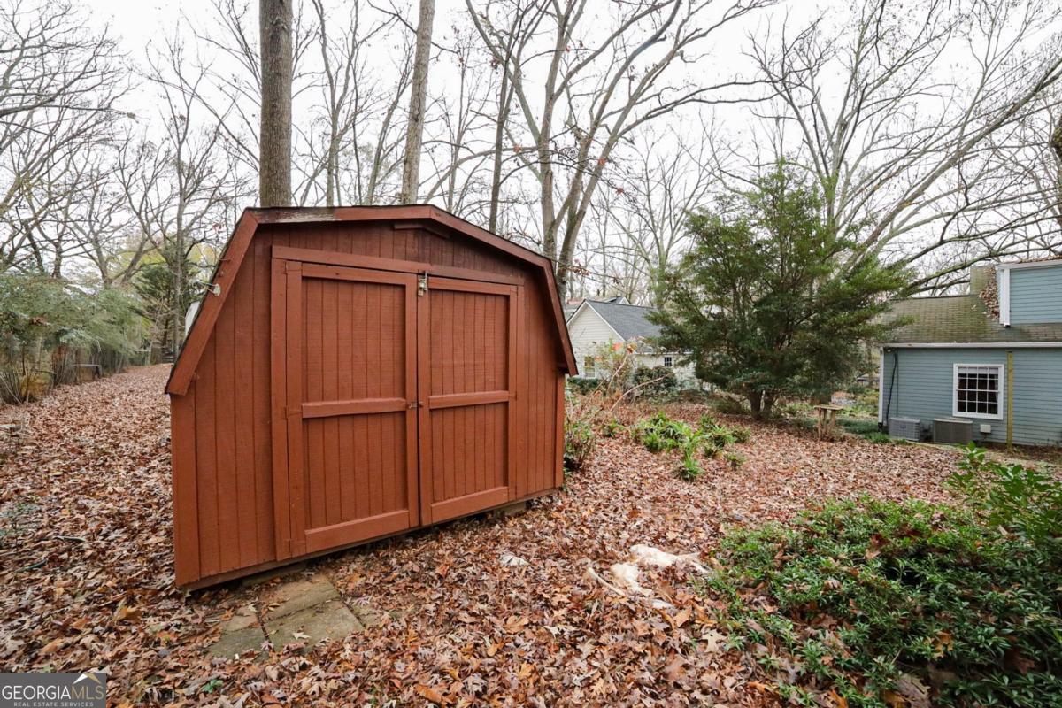158 Lakeover Drive Athens, GA 30607 - Photo 37 of 48 a backyard of a house with wooden fence and large trees