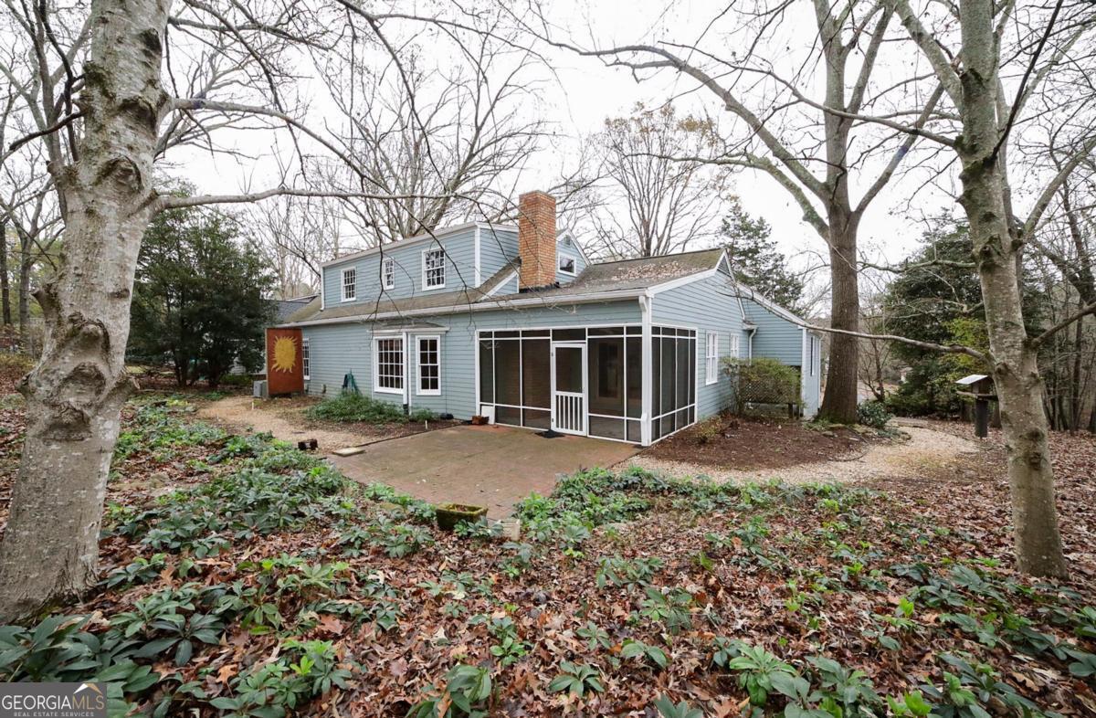 158 Lakeover Drive Athens, GA 30607 - Photo 40 of 48 a front view of a house with a garden and trees