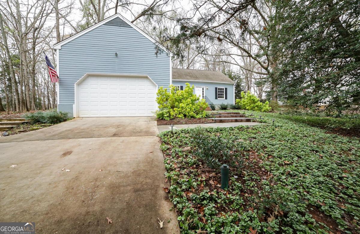 158 Lakeover Drive Athens, GA 30607 - Photo 45 of 48 a front view of a house with a yard and garage