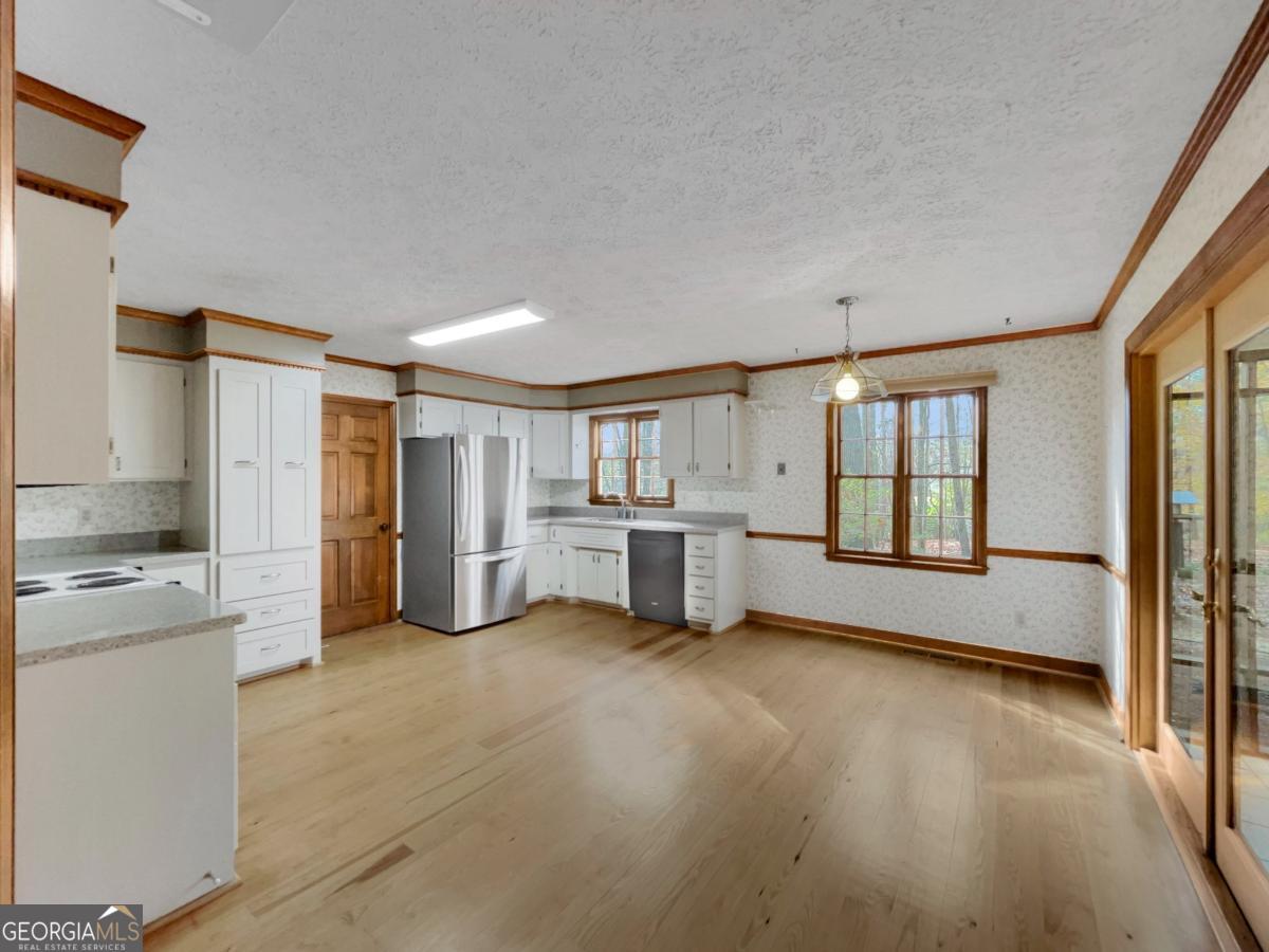 158 Lakeover Drive Athens, GA 30607 - Photo 9 of 48 a view of a kitchen with a sink and dishwasher a refrigerator with wooden floor