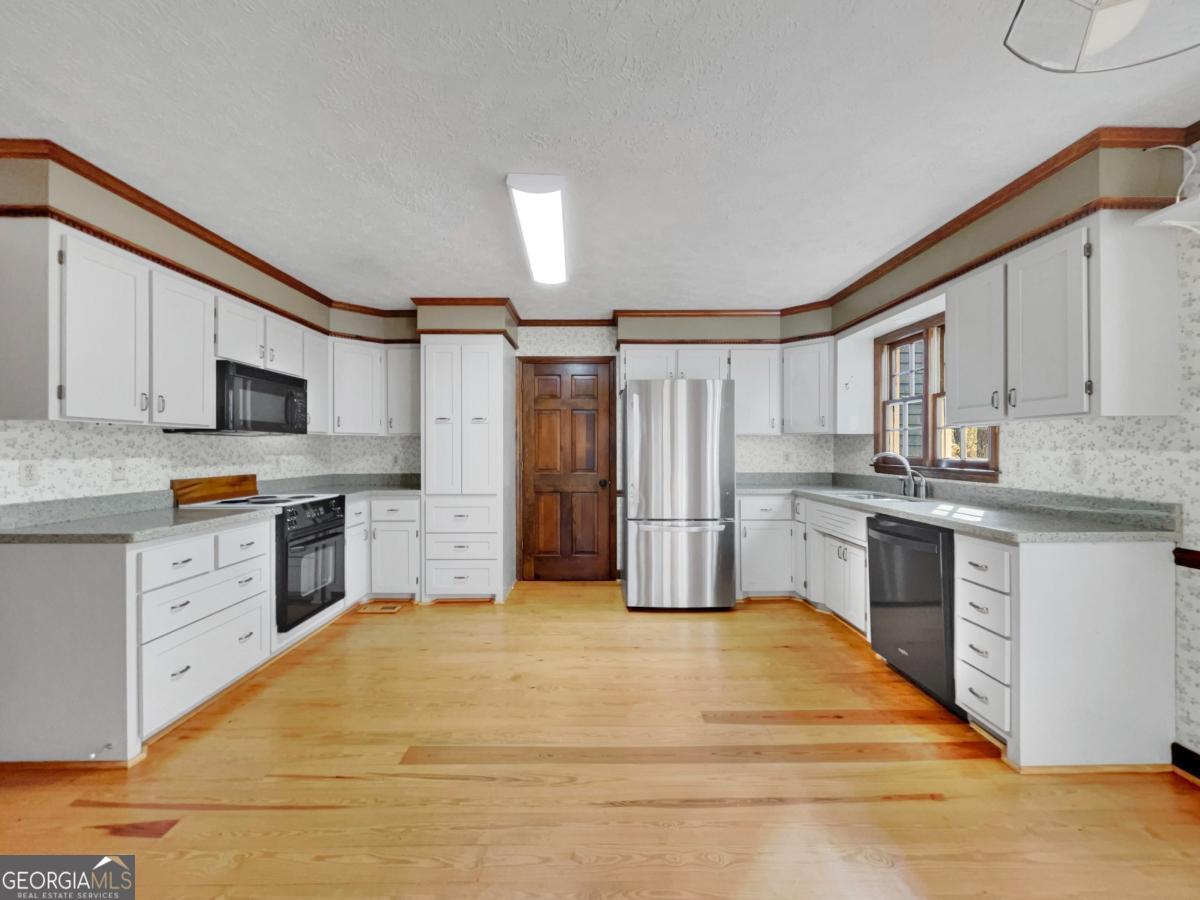 158 Lakeover Drive Athens, GA 30607 - Photo 10 of 48 a kitchen with granite countertop a sink cabinets stainless steel appliances and a counter space