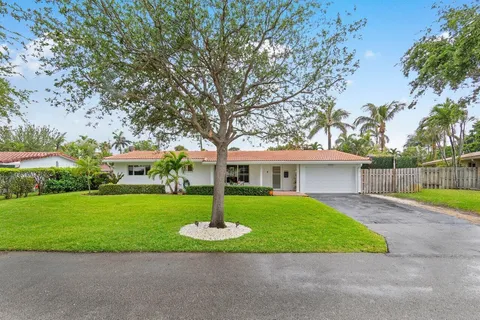 a front view of a house with a garden and yard