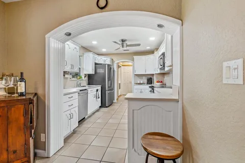 a kitchen with a sink a stove cabinets and a refrigerator