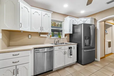 a kitchen with stainless steel appliances granite countertop a refrigerator and a stove
