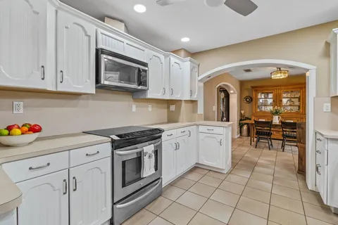 a kitchen with granite countertop cabinets and steel stainless steel appliances