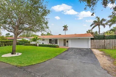 a view of a house with a yard and a garden